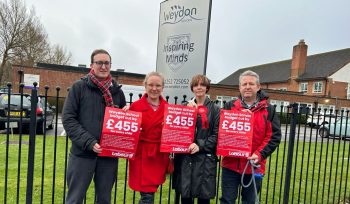 Four Labour Campaigners Hold Protest Signs Outside Weydon School in Farnham